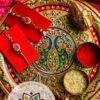 Radiant Unity: Oval Ruby Bhaiya Bhabhi Rakhi Set